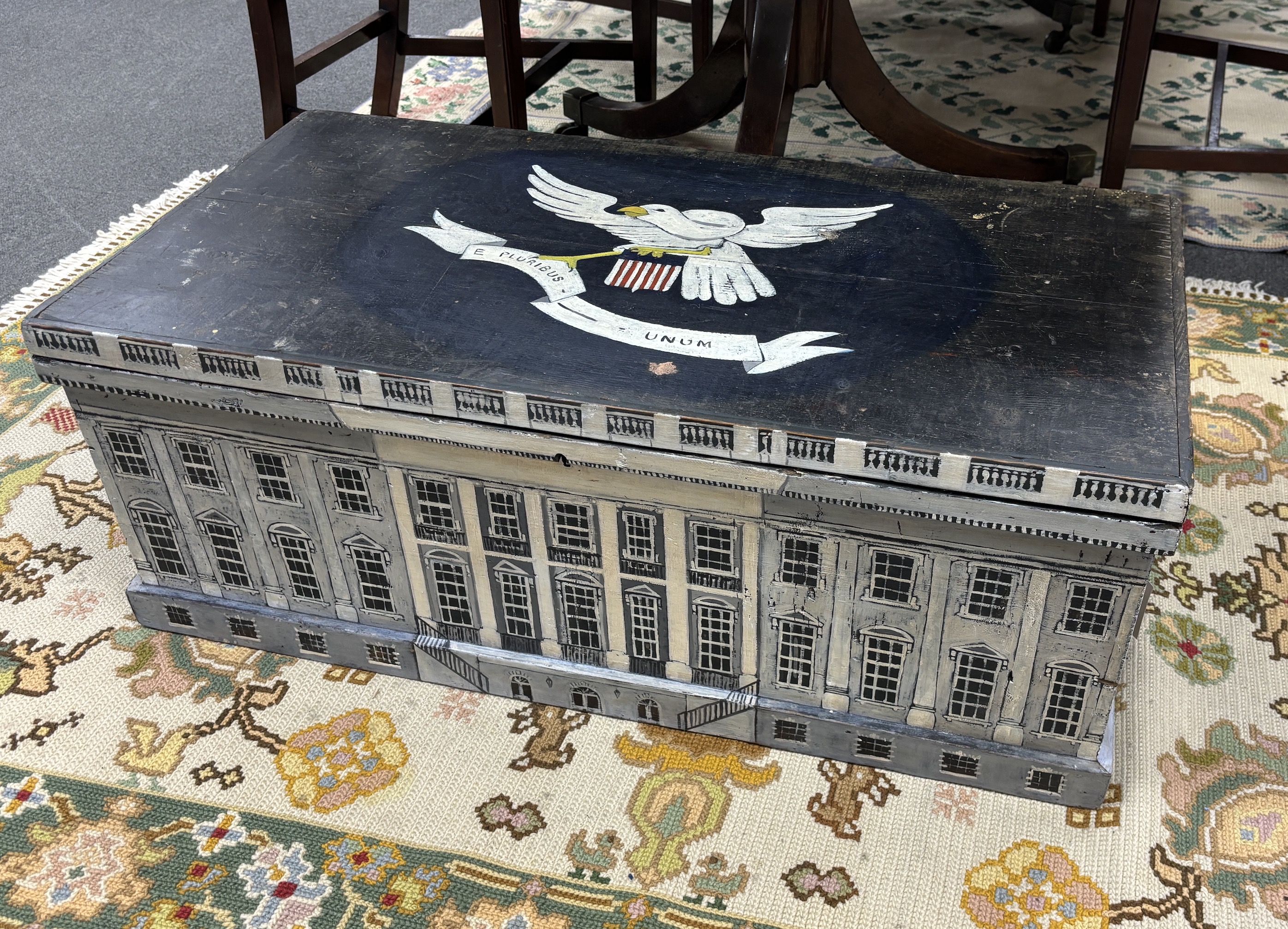 A 19th century pine trunk, later painted with a depiction of The White House and an American crest, width 88cm, depth 46cm, height 34cm